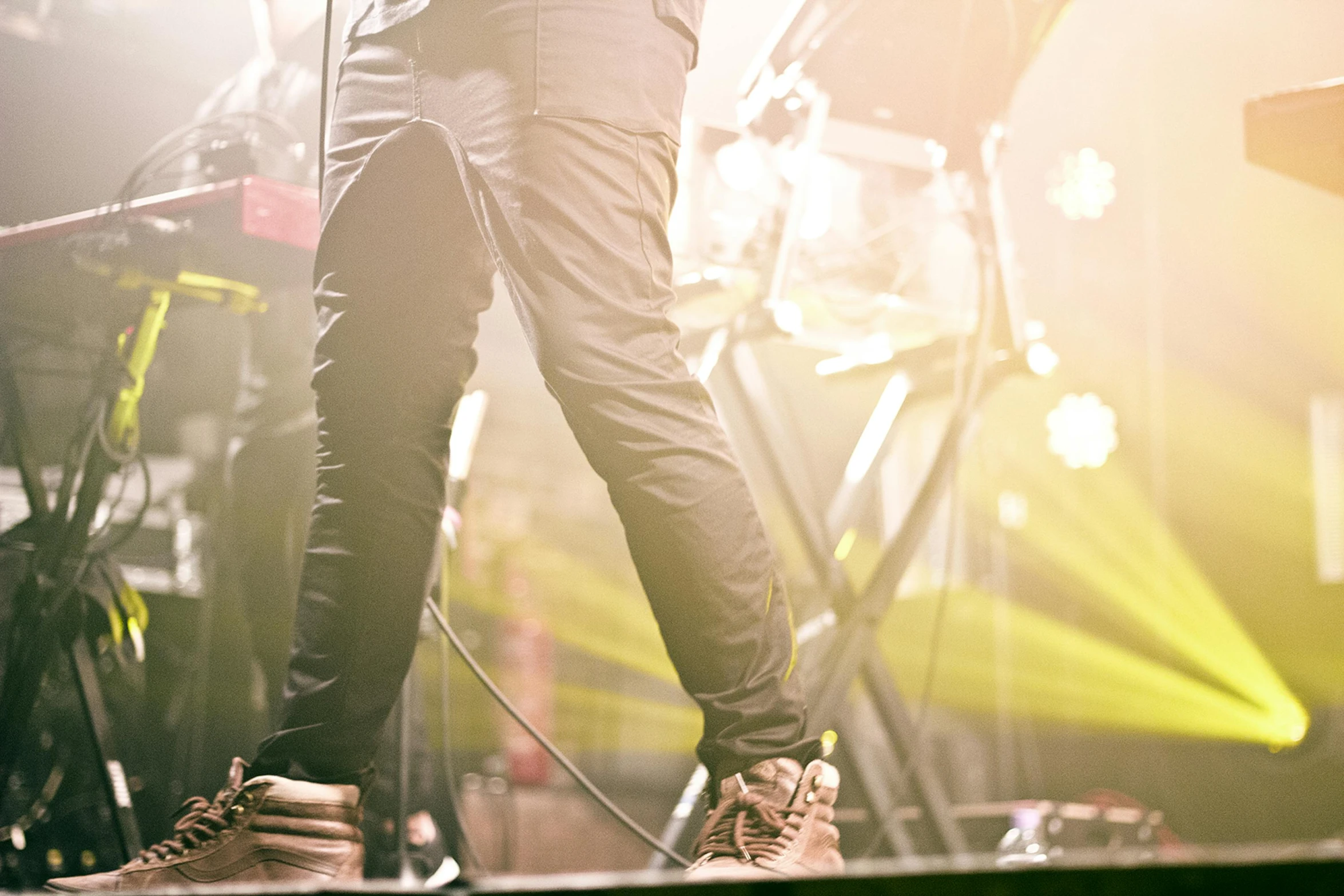 a man standing on top of a stage holding a microphone, pexels, happening, detailed shot legs-up, cargo pants, rock concert, avatar image