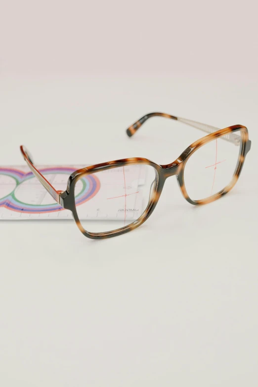 a pair of glasses sitting on top of a table, behance, square pictureframes, close up front view, kasumi arimura style 3/4, diffraction grading