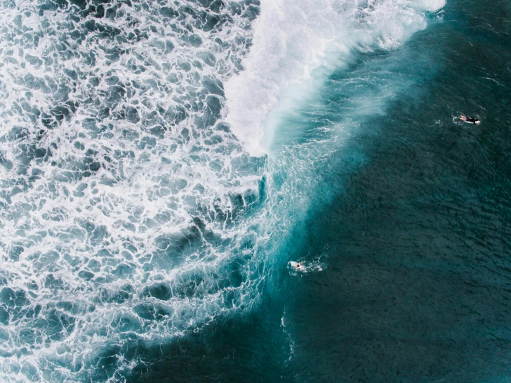 a man riding a wave on top of a surfboard, pexels contest winner, minimalism, helicopter view, thumbnail, turbulent sea, reefs