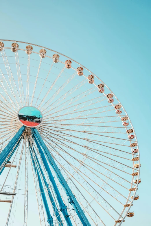a ferris wheel in front of a blue sky, pastel blue, instagram post, profile image, amusement park buildings