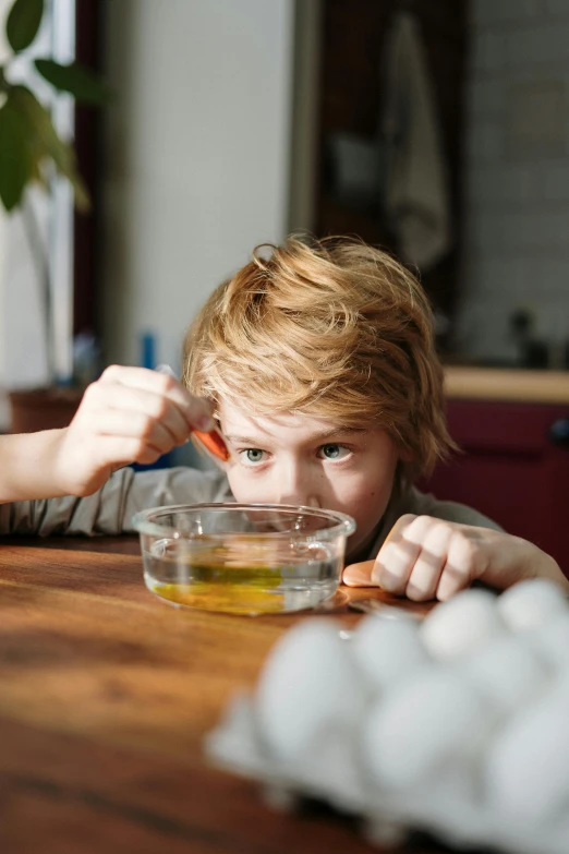 a little boy that is sitting at a table, bowl filled with food, oils, quiet intensity, high school