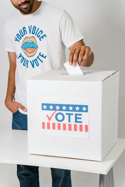 a man putting a vote in a box, by Everett Warner, shutterstock contest winner, white and teal garment, teenager, 2 0 2 2 photo, 100lb cardstock