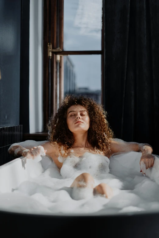a woman taking a bubble bath in a bathtub, trending on pexels, renaissance, wavy hair spread out, skies behind, relaxing after a hard day, foamy bubbles