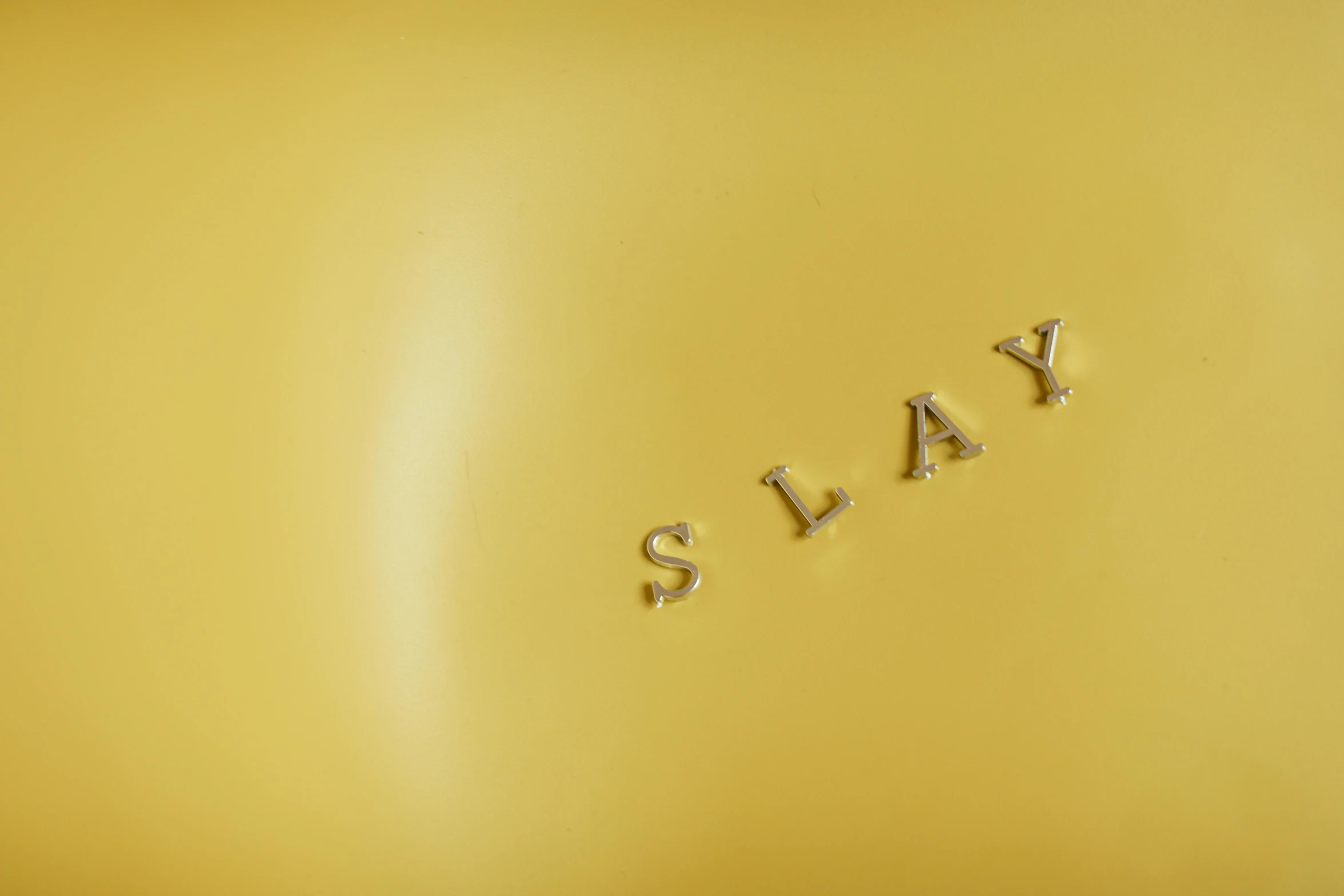 a yellow bag with the word galaxy written on it, an album cover, by Peter Alexander Hay, trending on unsplash, 3 d clay sculpture, slay, plate, detail shot