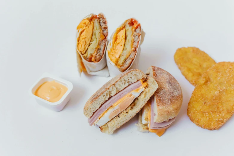 a sandwich cut in half with a side of potato chips, a portrait, by Carey Morris, pexels, renaissance, chicken nuggets, white and orange, various posed, 3 - piece