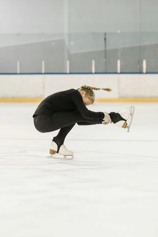 a female figure skating on an ice rink, pexels contest winner, arabesque, caps sideways, a blond, profile image, black