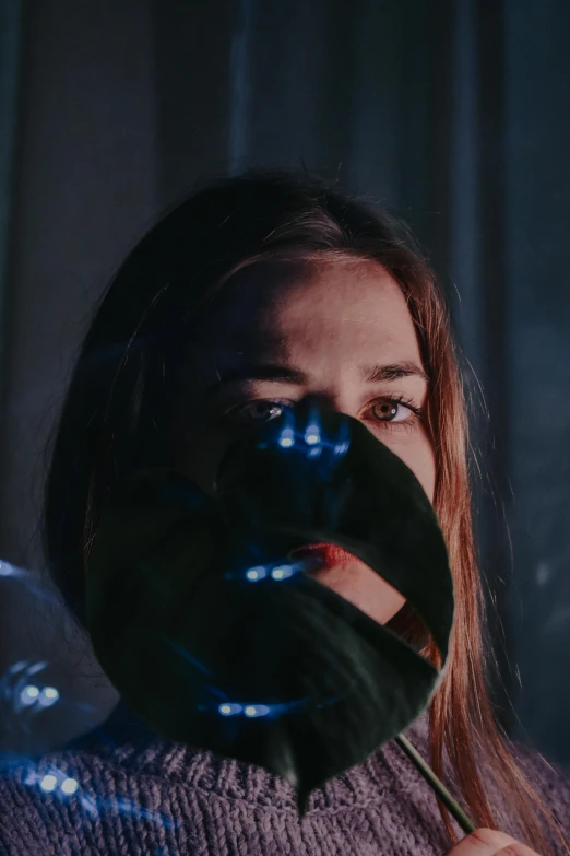 a woman with a mask covering her face, inspired by Elsa Bleda, trending on pexels, from a 2 0 1 9 sci fi 8 k movie, glowing hands, looking serious, sydney sweeney