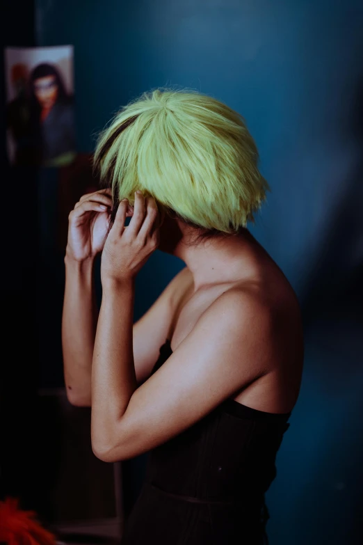 a woman with green hair talking on a cell phone, inspired by Nan Goldin, trending on pexels, visual art, wearing yellow croptop, facepalm, iridescent hair, short hair