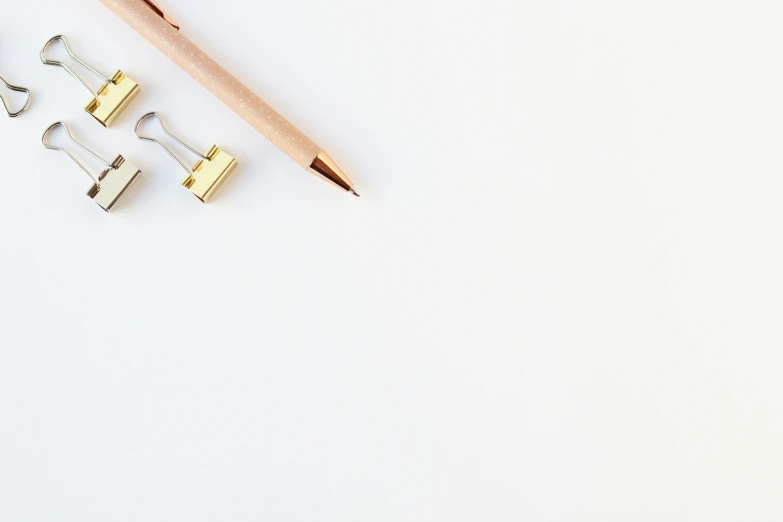 a pencil, paper clips, and a pair of scissors on a white surface, trending on unsplash, minimalism, beige and gold tones, !pencil, background image, minimalist svg
