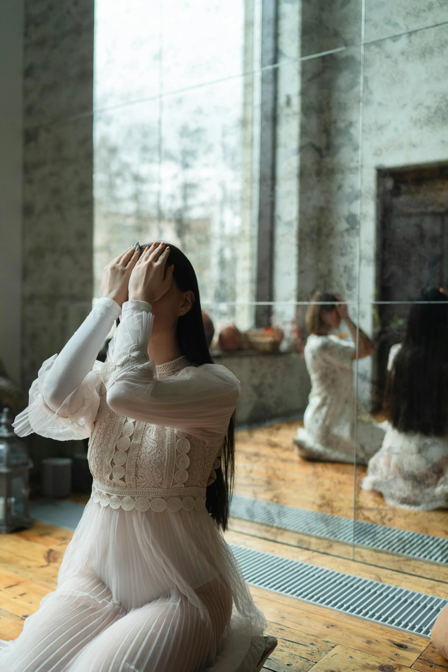 a woman sitting on the floor in front of a mirror, pexels contest winner, romanticism, wearing a white folkdrakt dress, terrified, ( ( theatrical ) ), louise zhang