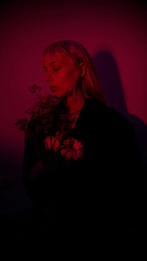 a woman standing in front of a pink wall, an album cover, inspired by Elsa Bleda, pexels contest winner, red neon roses, standing with a black background, lily frank, profile image