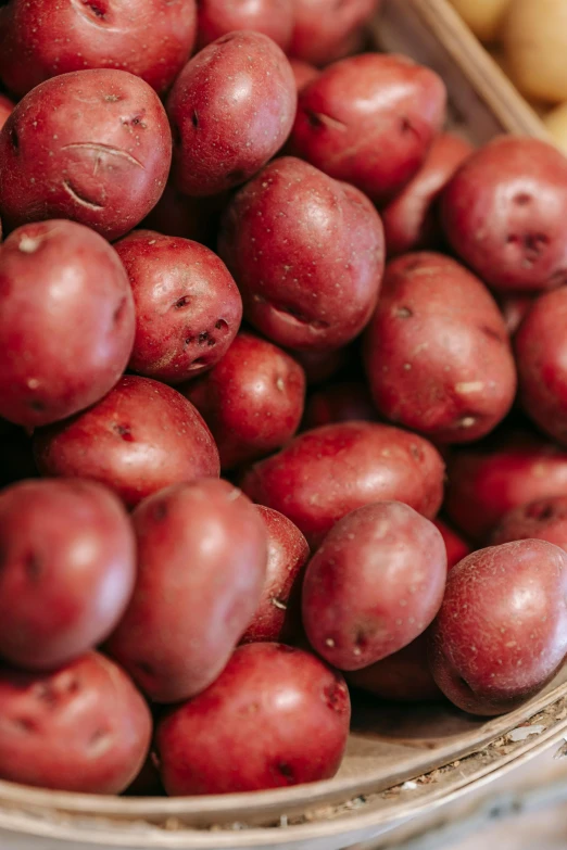 a bowl of red potatoes sitting on top of a table, uncrop, zoomed in, lots of light, group photo