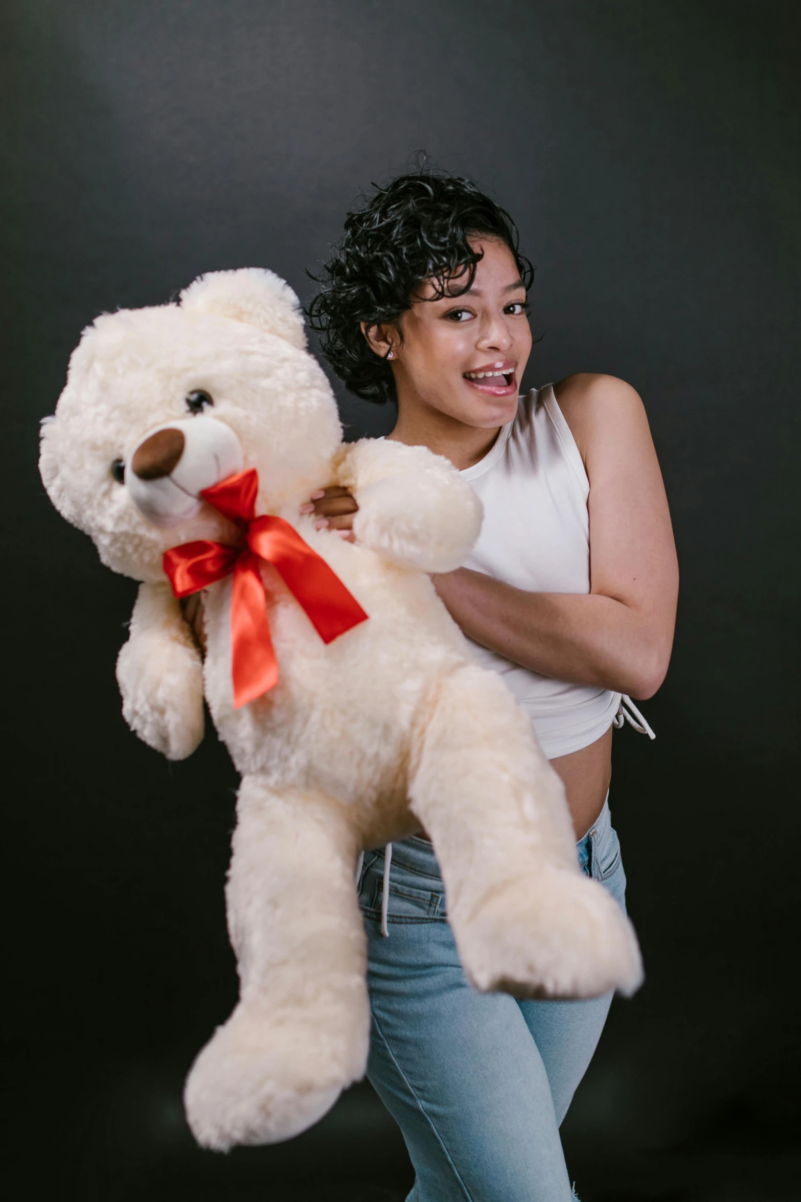 a woman holding a large white teddy bear, by Robbie Trevino, ready to model, excited, light skin, 2070