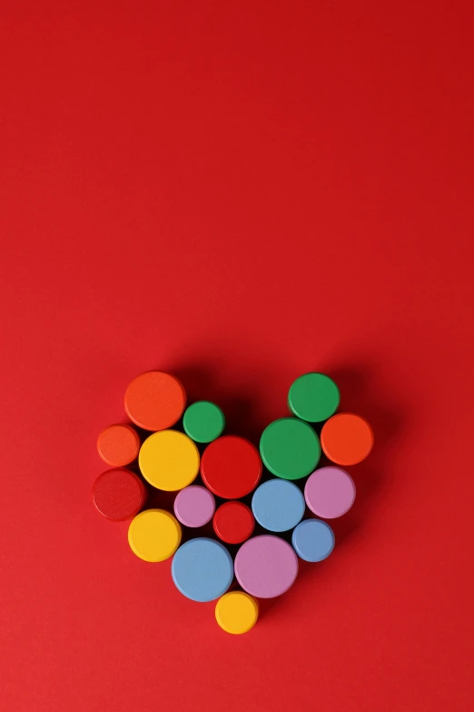 a heart made out of colored circles on a red background, pexels contest winner, cans, building blocks, tubes, colorul