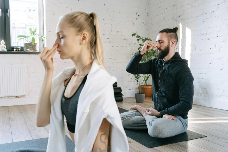 a man and a woman doing yoga together, a photo, trending on pexels, spitting cushions from his mouth, wearing a grey robe, profile image, acupuncture treatment