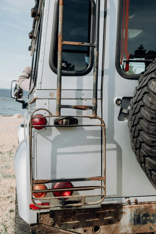 a white truck parked on top of a sandy beach, a picture, unsplash, tail lights, land rover defender 110 (1985), ladder, near lake baikal