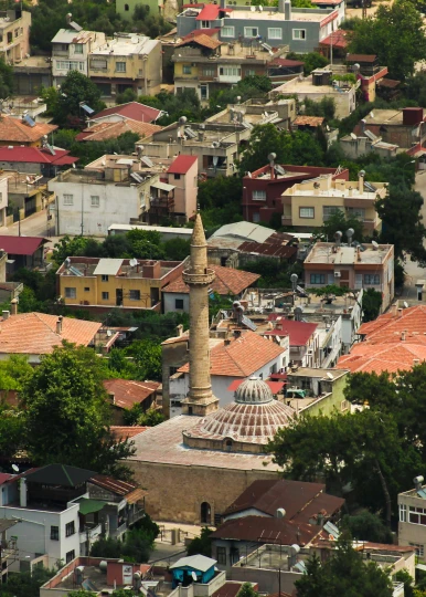 a view of a city from the top of a hill, mosque, tiled roofs, beige, multicoloured