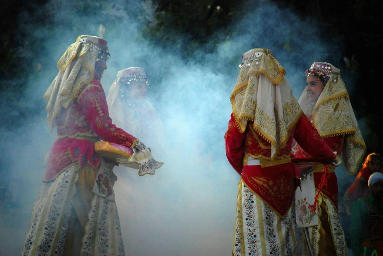 a group of people that are standing in the smoke, hurufiyya, embroidered brocade robes, smoke out of her eyes, slide show, multiple stories