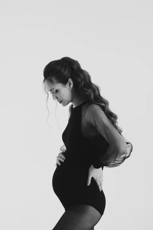 a black and white photo of a pregnant woman, elegant profile pose, cynthwave, sadness personified, r&b