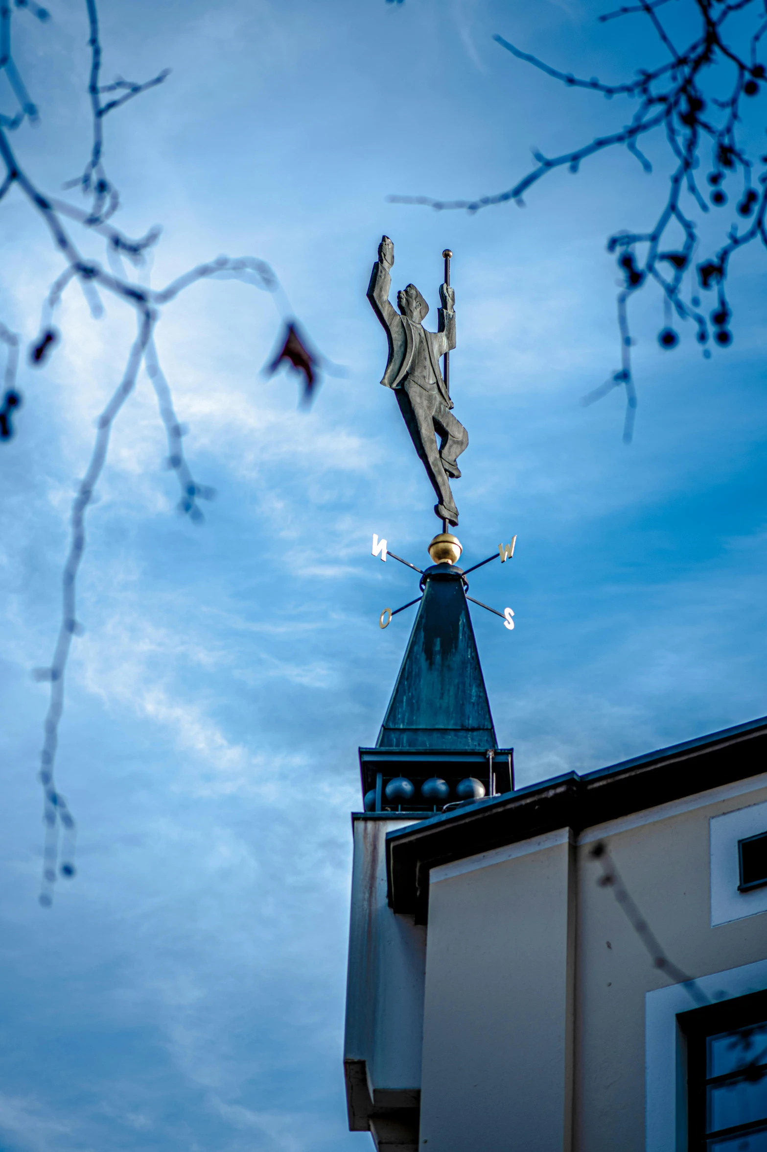 a clock tower with a weather vane on top of it, a statue, by Sven Erixson, unsplash, detmold, high quality photo, female ascending, taken with sony alpha 9