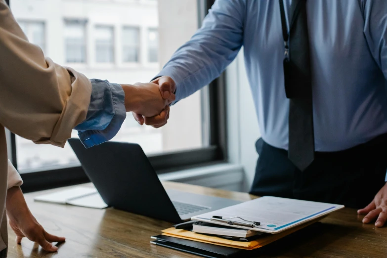 two men shaking hands in front of a laptop, pexels contest winner, holding a staff, lachlan bailey, business meeting, background image