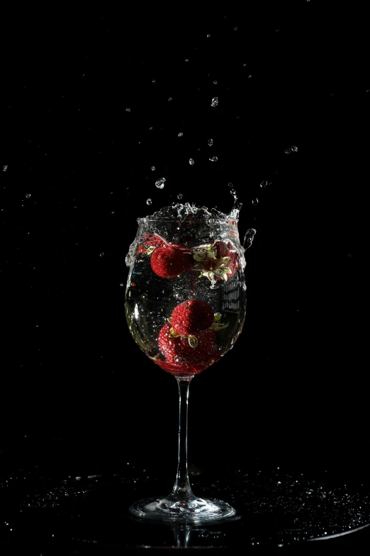 a glass of water with strawberries in it, an album cover, pexels, photorealism, ignant, sparkling spirits, wine, with a black background