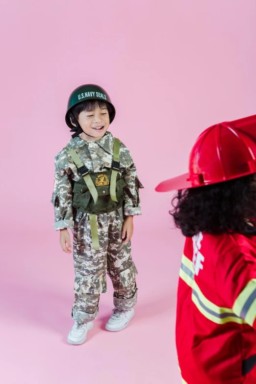 a little boy dressed up as a fireman, pexels contest winner, camouflage uniform, biopunk toys made in china, full product shot, opening shot