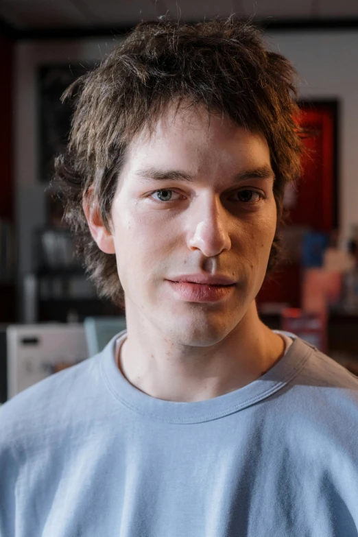 a close up of a person holding a nintendo wii controller, a character portrait, by Jacob Toorenvliet, handsome detailed face, light stubble with red shirt, nonbinary model, 8k highly detailed face