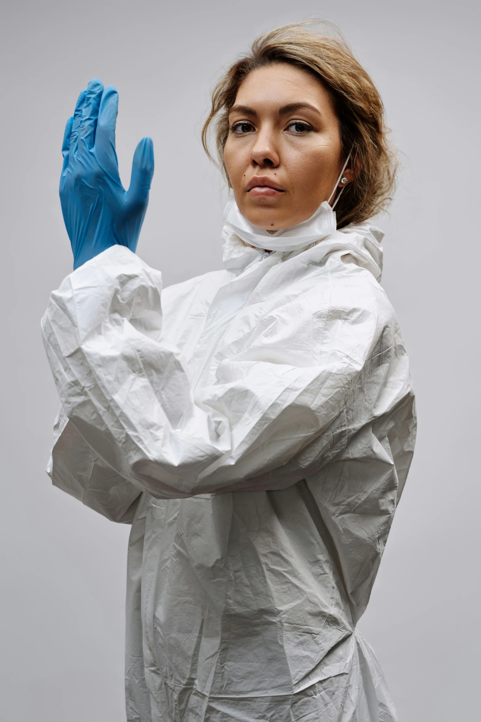 a woman in a white lab coat and blue gloves, by Paul Davis, plasticien, on grey background, coronavirus, wearing a tracksuit, gemma chen