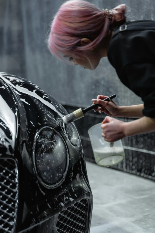 a woman with pink hair washing a black car, by An Gyeon, hyperrealism, skin detail, photographed for reuters, nier autoamata, made of smooth black goo