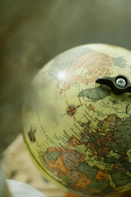 a close up of a small globe on a table, adventure, ivory, thumbnail, list