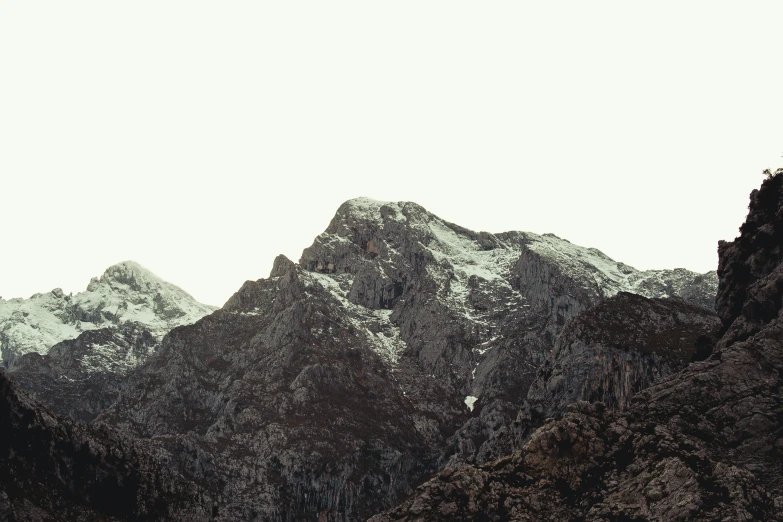 a black and white photo of a mountain range, inspired by Zhang Kechun, unsplash, minimalism, frank moth, photographic print, brown, snowy apennines