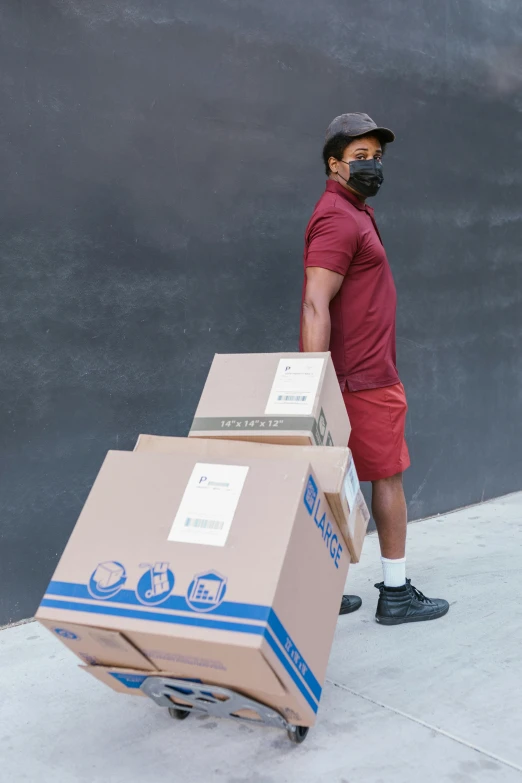 a man pushing a cart with boxes on it, a stock photo, pexels contest winner, renaissance, maroon, wearing facemask, ( ( dark skin ) ), full body shot close up