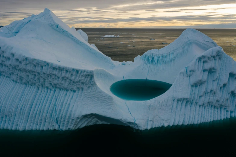 an iceberg with a hole in the middle of it, pexels contest winner, land art, helicopter view, 2 0 2 2, inuit, ignant