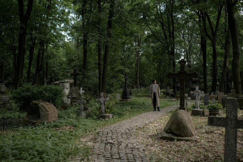 a man standing in the middle of a cemetery, inspired by Max Švabinský, production photo, lush surroundings, cobblestones, 2 0 2 2