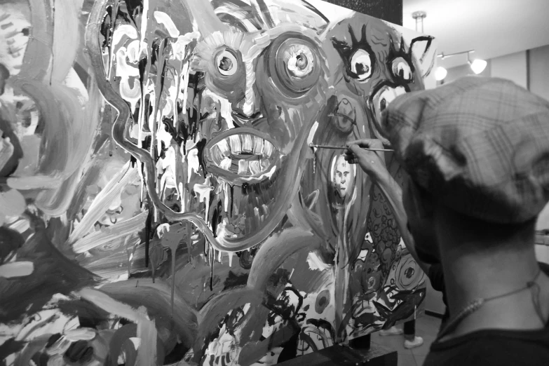 a man that is standing in front of a painting, inspired by Otto Dix, process art, black and white monochrome, with multiple eyes, painting a canvas, mouth of hell