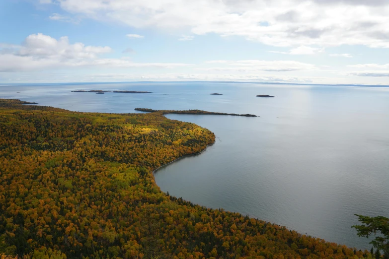 a large body of water surrounded by trees, by Thomas Furlong, pexels contest winner, hurufiyya, an island made of caviar, minn, fall, archipelago