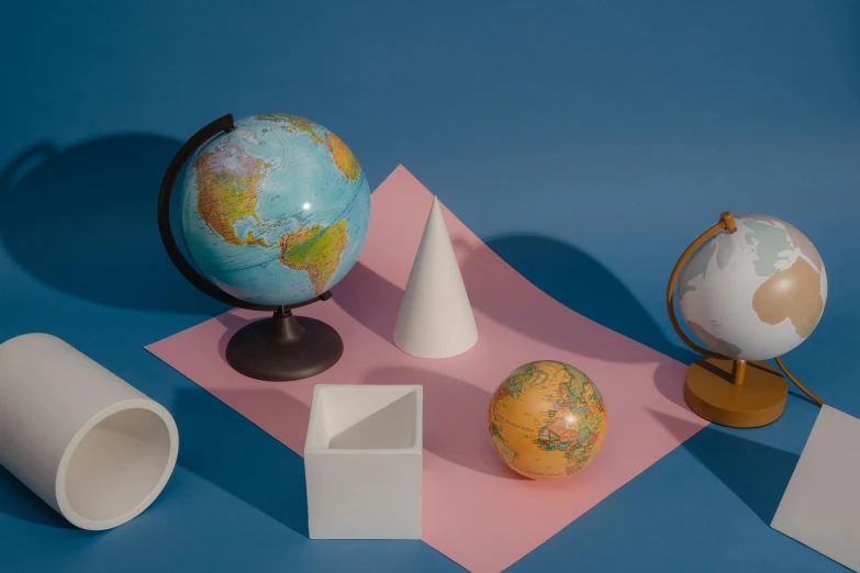 a globe sitting on top of a pink piece of paper, white ceramic shapes, solid shapes, blue moon ray tracing, mapbox