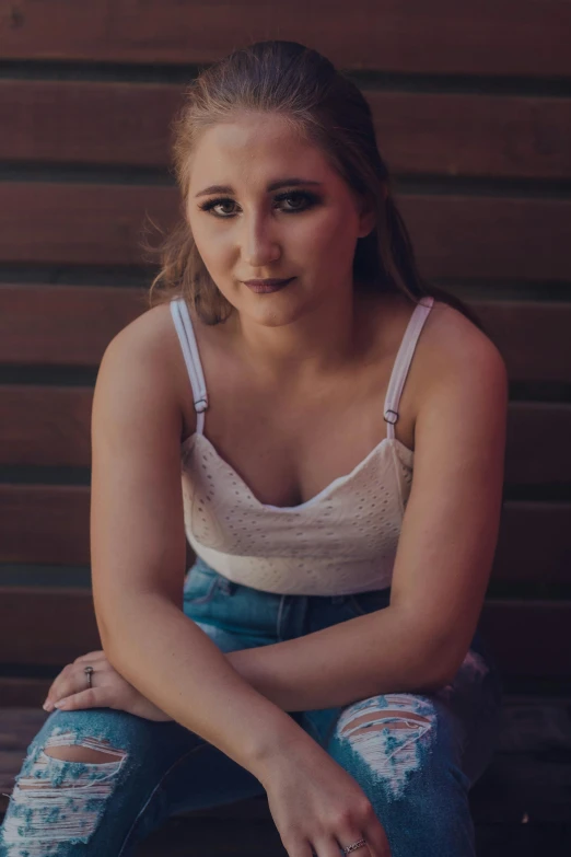 a beautiful young woman sitting on top of a wooden bench, inspired by Elsa Bleda, unsplash, photorealism, 🤤 girl portrait, jenna barton, concert photo, portrait of white teenage girl