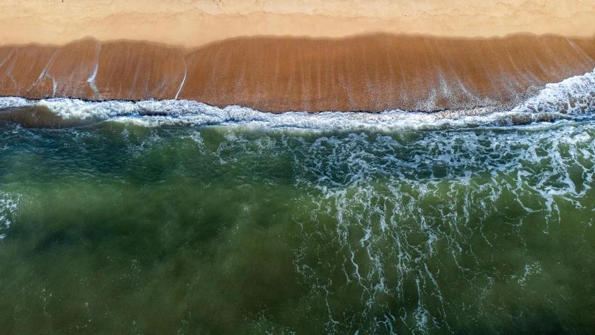 a large body of water next to a sandy beach, by Niko Henrichon, pexels contest winner, renaissance, two colors, close-up from above, 15081959 21121991 01012000 4k, 2000s photo