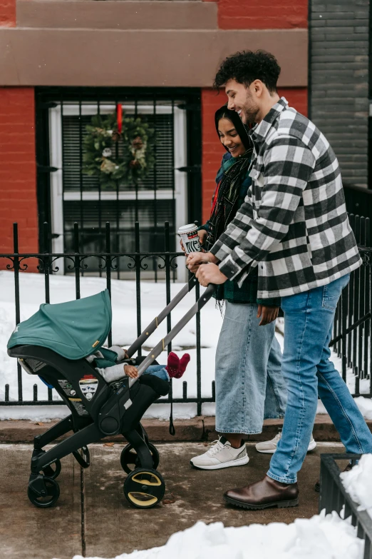 a man pushing a baby in a stroller, a picture, pexels contest winner, holiday vibe, celtics, 3 - piece, holding hand