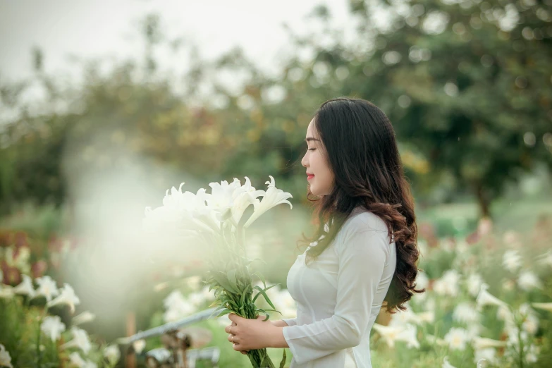 a woman holding a bunch of flowers in a field, pexels contest winner, white lilies, vietnamese woman, 15081959 21121991 01012000 4k, profile pic