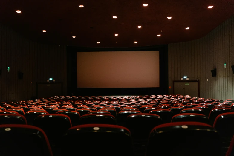 a large auditorium with rows of seats and a projector screen, pexels, video art, blockbuster movie, instagram post, cinestill colour, analogue