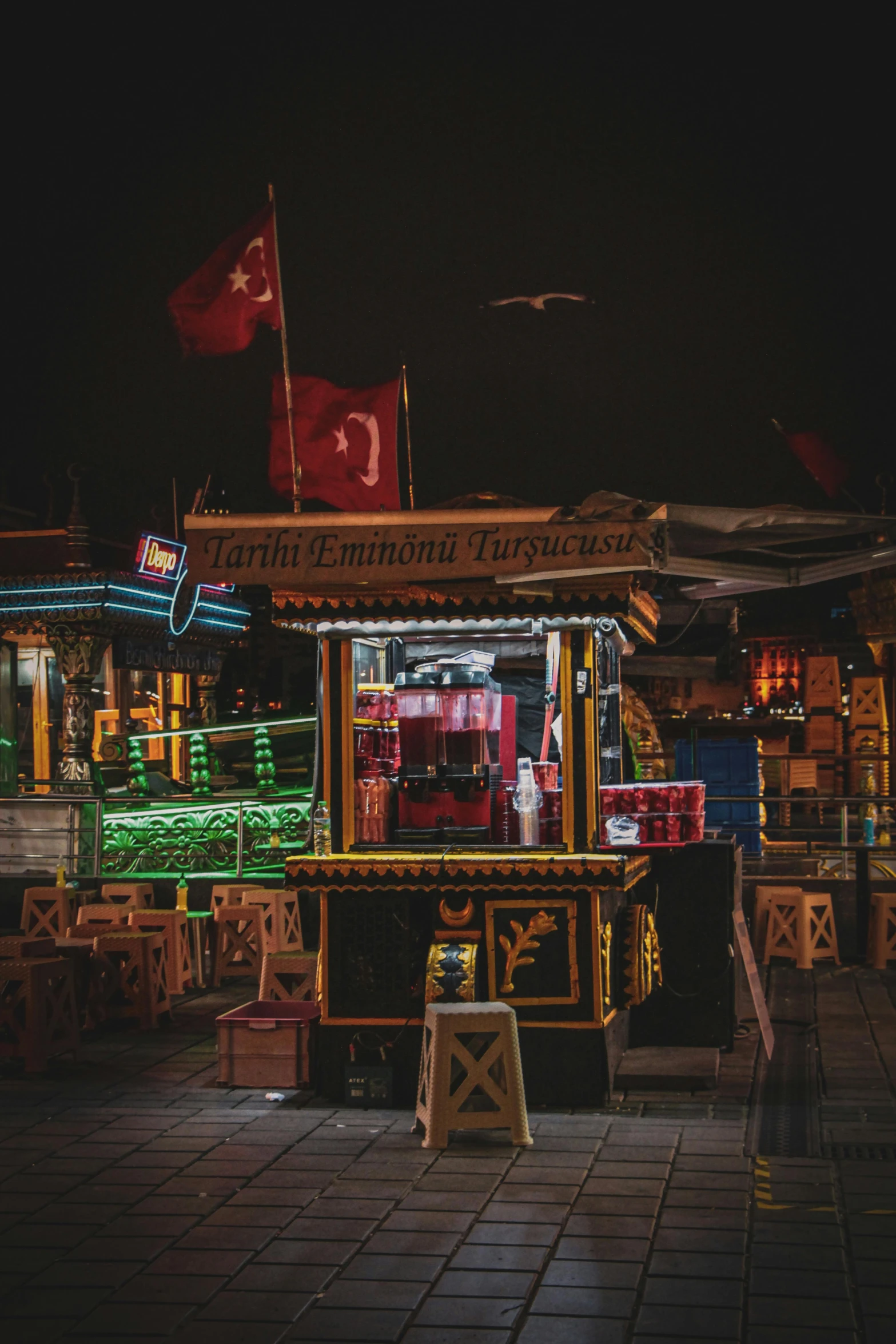 a food stand is lit up at night, by Julia Pishtar, pexels contest winner, hurufiyya, red flags holiday, square, turkey, low quality photo