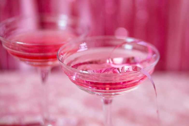 a couple of wine glasses sitting on top of a table, by Alice Mason, pexels, pink and pink details, vodka, cosmopolitan, profile image