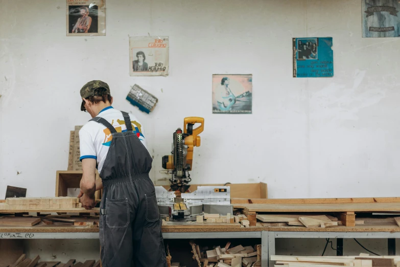 a man working in a woodworking shop, pexels contest winner, arbeitsrat für kunst, risograph, wooden desks with books, white wall coloured workshop, profile image