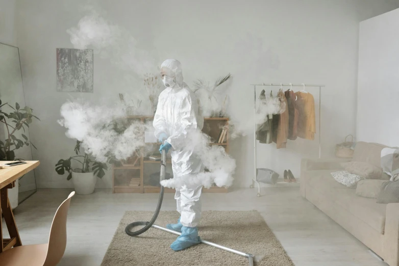 a person in a room with a vacuum and smoke coming out of it, wearing a plug suit, covid, thumbnail, sterile minimalistic room