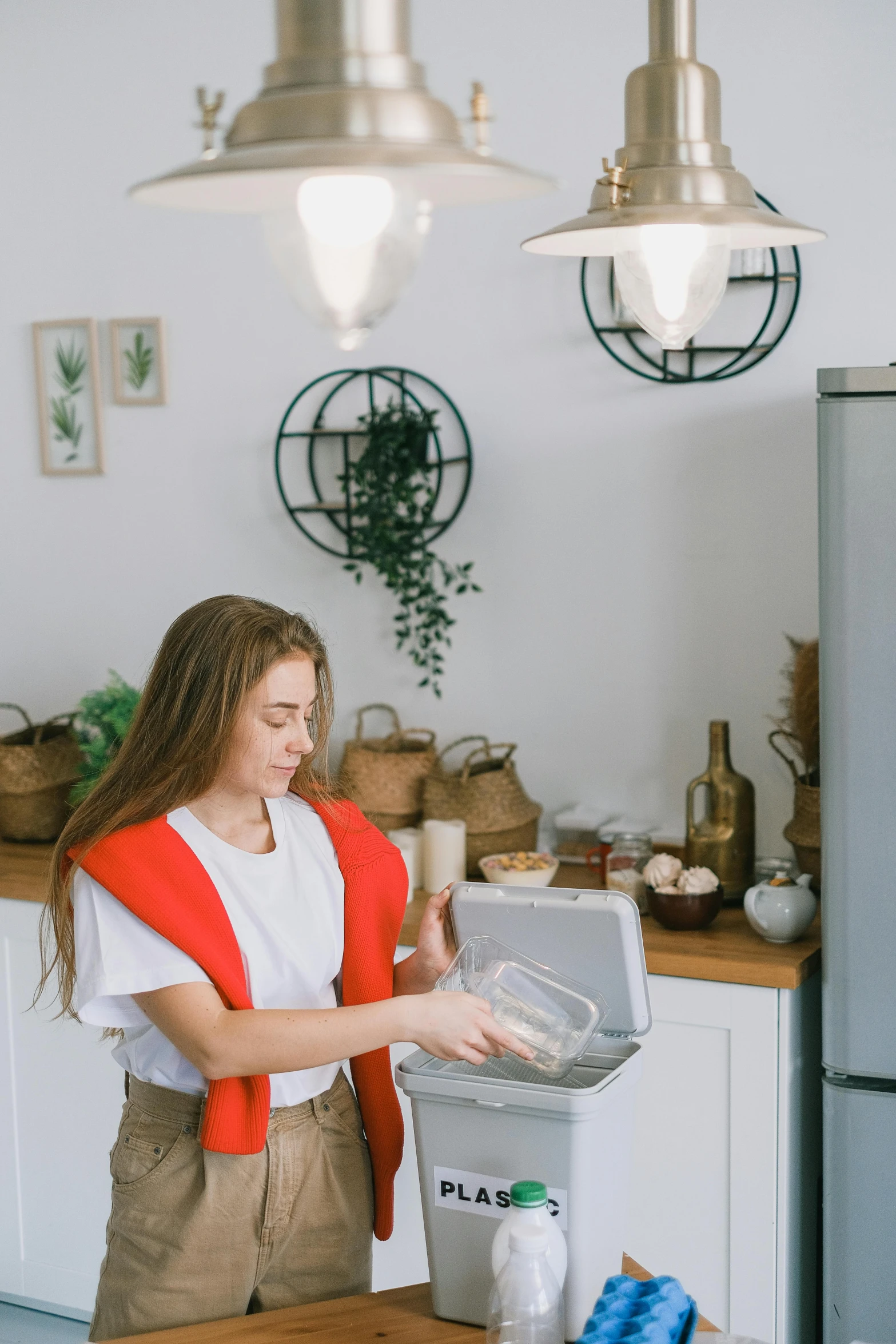 a woman standing in a kitchen next to a refrigerator, pexels contest winner, carrying a tray, wearing a cute top, connectivity, low quality photo