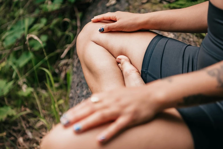 a woman sitting on a log in the woods, unsplash, renaissance, thighs close up, acupuncture treatment, swollen muscles, manuka