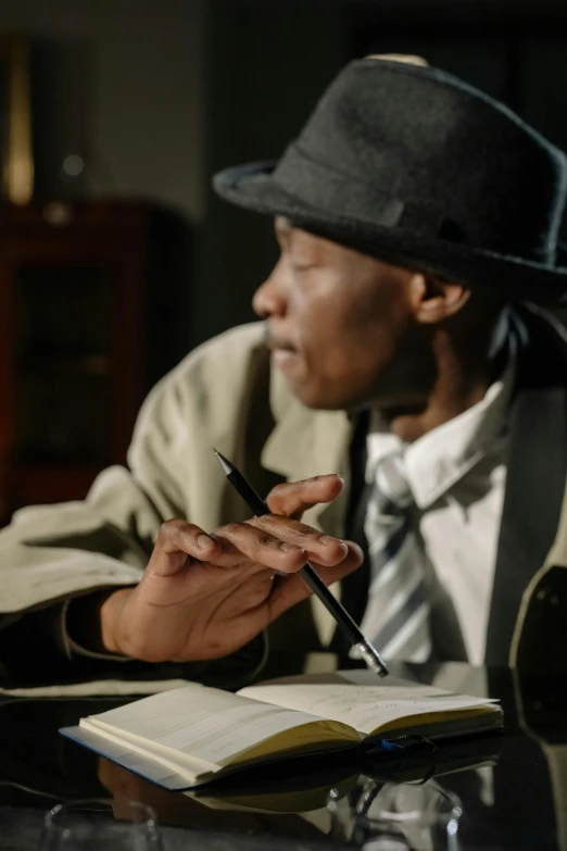 a man sitting at a table writing in a book, detective clothes, black man, thumbnail, multiple stories